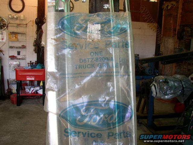 Ford service parts packaging with a truck grille inside. Part number D6TZ-8200-A is visible