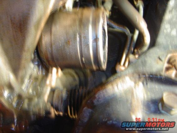 Close-up of engine components with oil and a timestamp