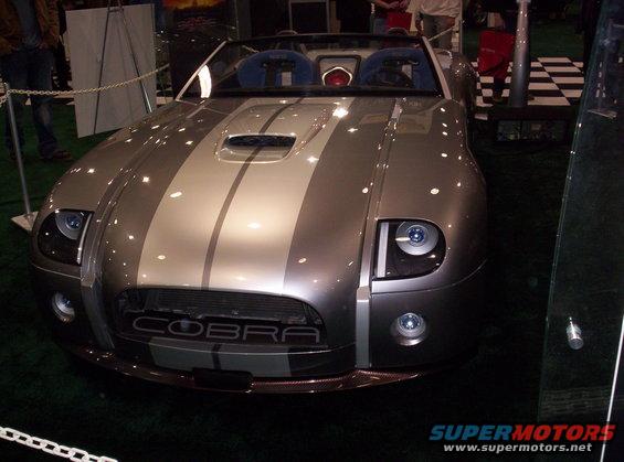 Silver convertible with racing stripes and 'COBRA' on grille