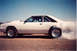1980 Mercury Capri - This white coupe, likely a Ford Mustang from the 1980s, performs a burnout with smoke billowing from the rear tire.