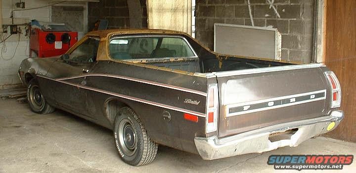 Rear view of a brown 1972 Ford Ranchero with a gold top, parked inside a garage