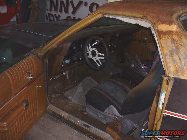 1972 Ford Ranchero interior with worn brown door panel and black seat