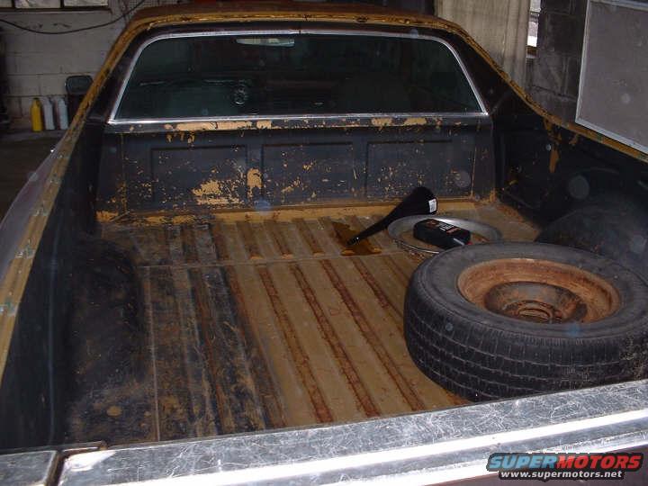 1972 Ford Ranchero pickup bed interior with spare tire and funnel