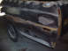 1972 Ford Ranchero - The side of a 1972 Ford Ranchero is undergoing bodywork, revealing primer and filler in various patches.