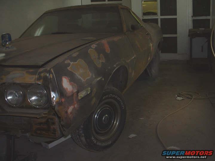 Front quarter view of a 1972 Ford Ranchero undergoing bodywork, showing primer and sanding marks