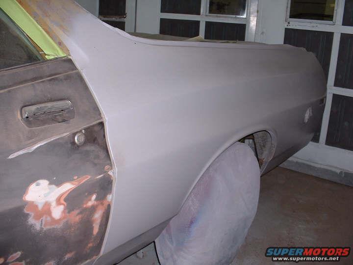 1972 Ford Ranchero side view, primer gray, undergoing bodywork, chrome door handle visible