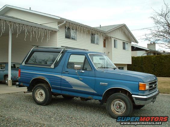 Blue 1990 Ford Bronco with silver side graphics