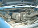 1990 Ford Bronco - Engine bay of a 1990 Ford Bronco, showing the engine and surrounding components under the hood.