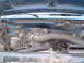 1990 Ford Bronco - The engine bay of a vehicle is shown, with visible hoses and engine components. Text on a part indicates a date of 12/92.