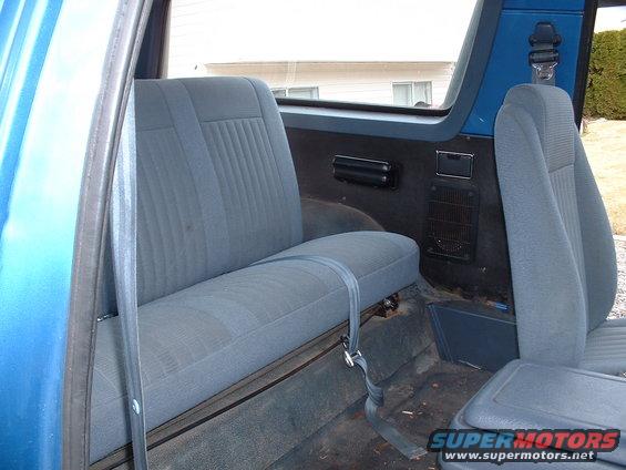 Blue interior with rear bench seat and front passenger seat visible