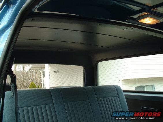 1990 Ford Bronco interior showing rear seat and headliner with dome light