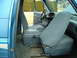 1990 Ford Bronco - The interior of a blue SUV, likely a 1990 Ford Bronco, shows cloth seats and a center console.