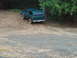 1978 Ford Bronco - A 1978 Ford Bronco navigates a muddy, wooded terrain.
