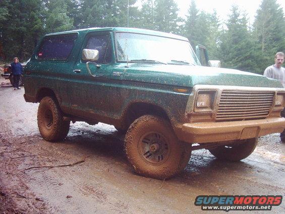 Green 1978 Ford Bronco on muddy road