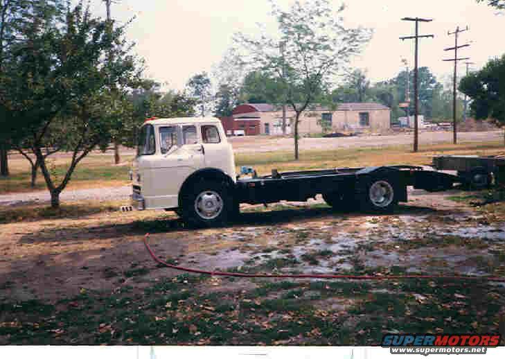 White cab-over truck chassis parked outdoors
