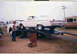 1957 Ford Deluxe - 1957 Ford Fairlane being loaded onto a car hauler with a man watching.