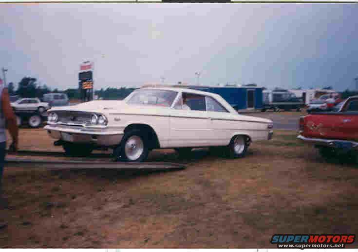 White 1963 Ford Galaxie coupe on a trailer, viewed from the front-right