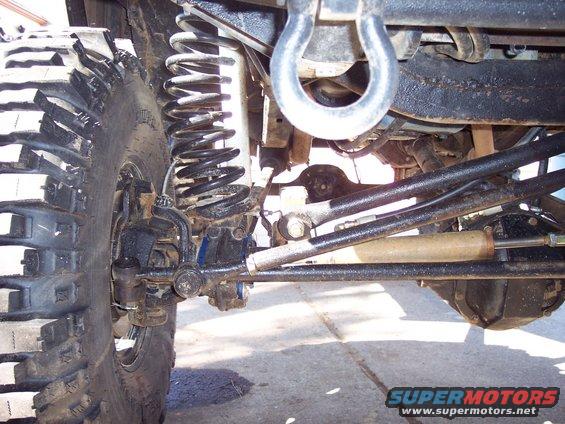 Close-up of off-road suspension with large tire and steering linkage