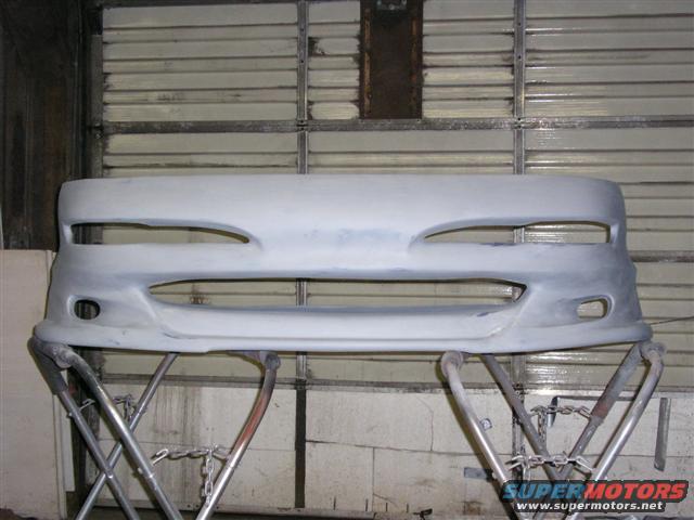 Unpainted car bumper on stand