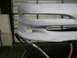 1994 Ford Probe - Car bumper is prepped for paint and mounted on a stand.