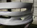 1994 Ford Probe - Close-up of a car bumper, likely undergoing preparation for painting.