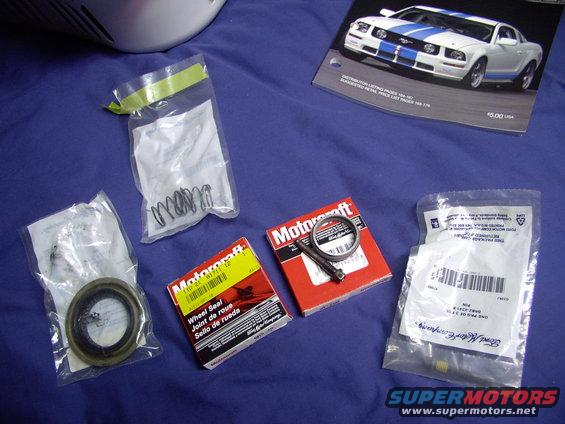 img_0407.jpg Pinion seal on the left (in bag), two outer axle seals in boxes, crush sleeve and pin lock bolt (old) and new one, with loctite in threads, in package below it