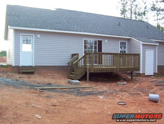 House with a wooden deck and siding