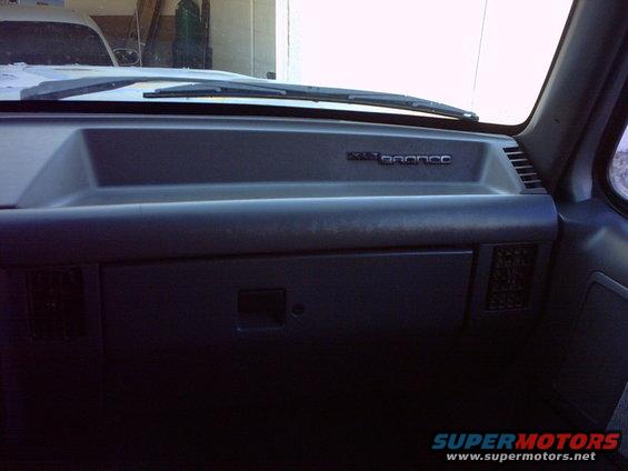 Dashboard of a 1990 Ford Bronco with 'BRONCO' badge visible