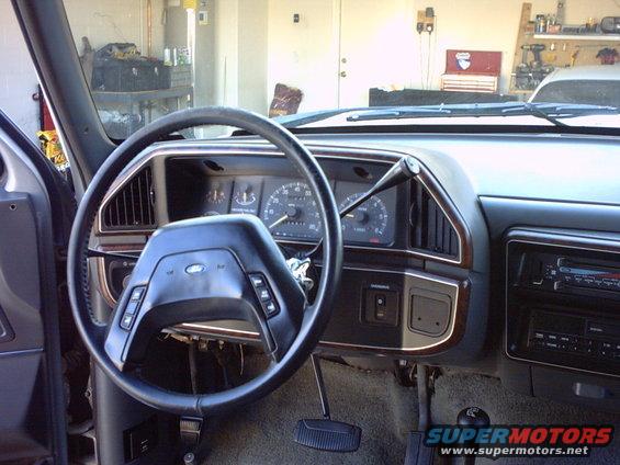 1990 Ford Bronco interior showing dashboard, steering wheel, and center console