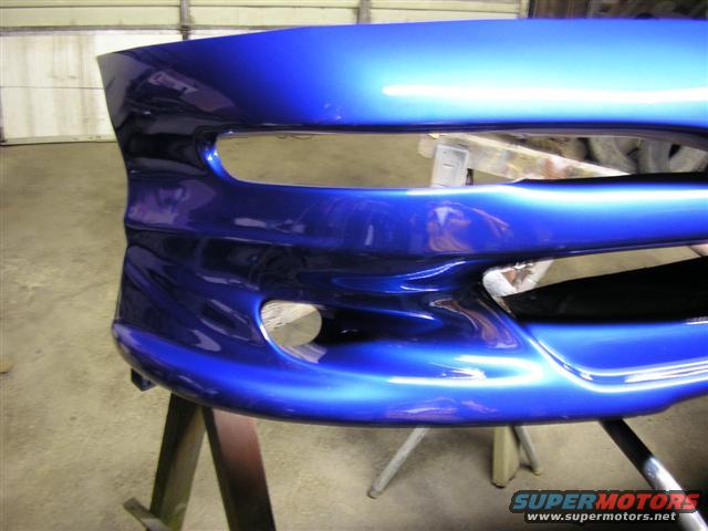 blue car bumper on sawhorses