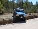 1979 Chevrolet C/K Pickup - Blue 1979 Chevrolet C/K Pickup navigates an off-road trail, with one tire in a ditch.