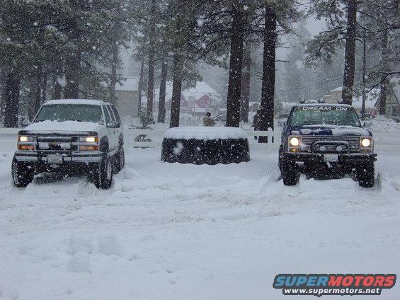 Blue pickup truck with "DREAM ON" on windshield, front view in snow
