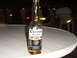 1988 Ford Bronco - A bottle of Corona Extra sits on a table at night, with a blurred background.