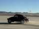 1969 Volkswagen Beetle - A modified 1969 Volkswagen Beetle races across a desert landscape, its rear end kicking up a cloud of dust.