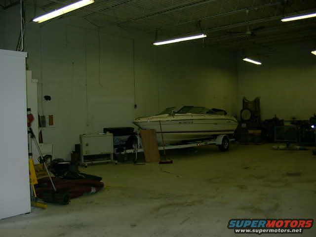 Boat on a trailer inside a warehouse, side view