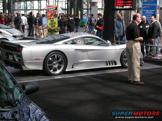 Silver Saleen S7 sports car with aggressive body kit and large rear spoiler, viewed from the rear three-quarter angle