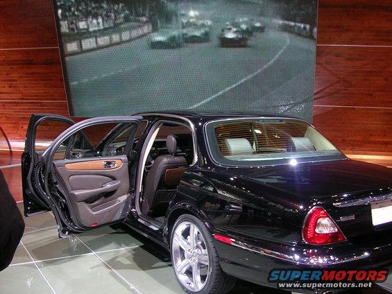 Black Jaguar sedan interior detail with wood trim and open doors