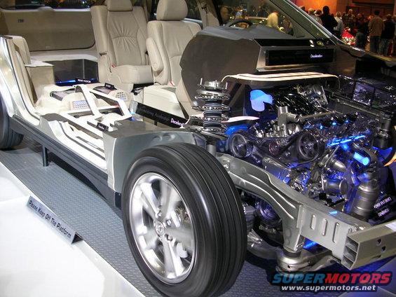 Cutaway view of a vehicle's chassis and engine, showing interior seating and suspension components