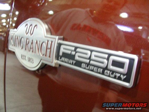 Ford F-250 Super Duty King Ranch Lariat badge on a red vehicle