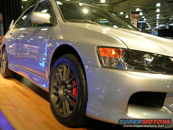 Silver Mitsubishi Lancer Evolution with aftermarket wheels and red brake calipers
