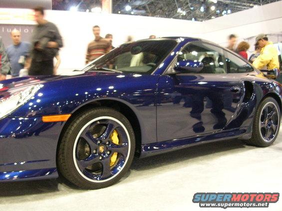 Blue Porsche 911 with yellow brake calipers and a Supermotors.net watermark