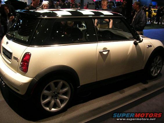 White Mini Cooper S with black checkered roof at a car show