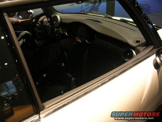 Interior view of a white car with a dashboard and steering wheel