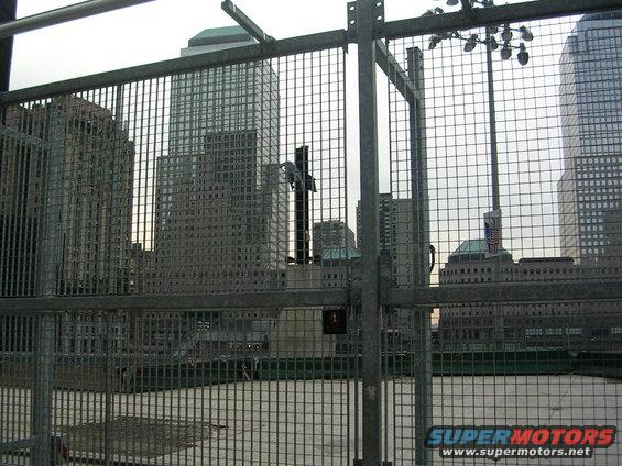 New York City skyline with buildings and a fence in the foreground
