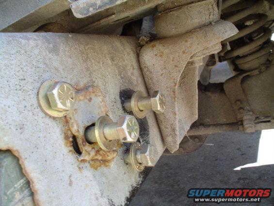 picture-073.jpg drilled one hole, then put the bolt in and tightened it up, aligned the peice with the frame, then took a 2lb hammer and tapped on the other 3 bolts to leave an imprint so I could drill the other holes in the right spot