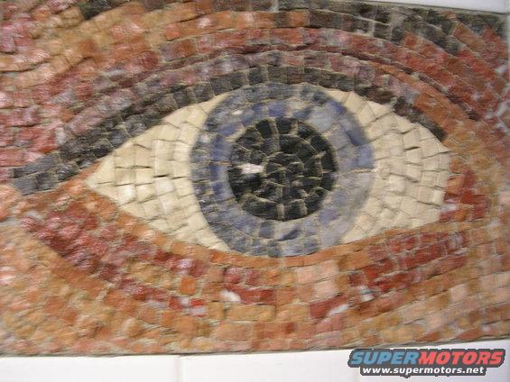 Mosaic eye with blue iris and brown eyelid, lower right corner has SUPERMOTORS logo