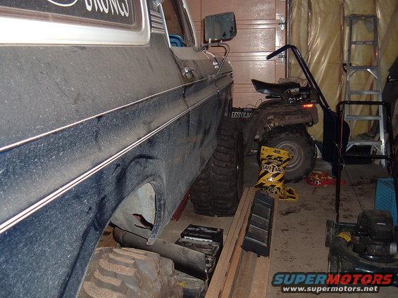 1979 Ford Bronco side view in garage with ATV and lawnmower