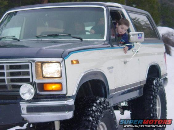 1986 Ford Bronco, 3q front view, white and blue with large tires