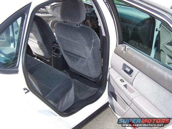 2001 Ford Taurus interior, gray cloth seats, open driver's door, dashboard visible