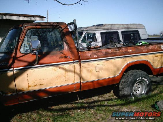 1978 Ford F-150 pickup truck, two-tone paint, side view. A van is parked behind it